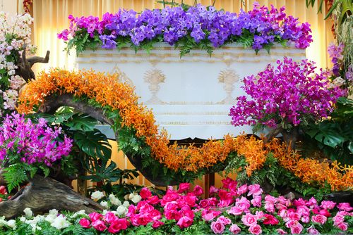 Casket Covered in Colorful Flowers