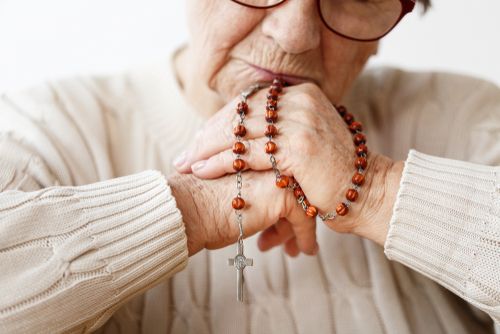 Elderly Woman Holding a Rosary