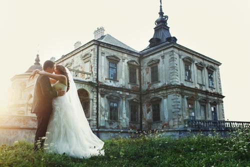 Groom and Bride in Front of a Castle