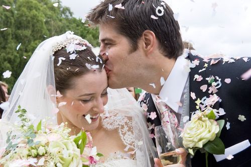 Groom Kissing Bride on the Forehead