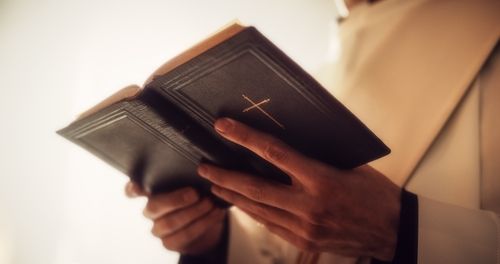 a minister holding bible