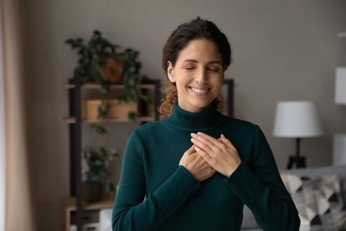 Person With Their Hands Over Their Heart