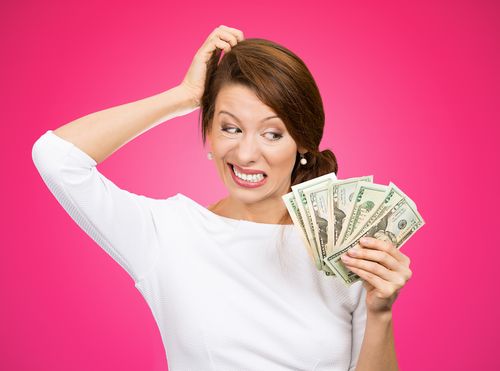 Woman Looking at Money and Scratching Her Head