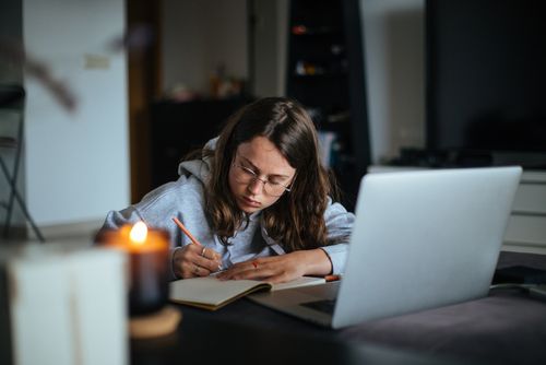 Woman Writing in a Notebook