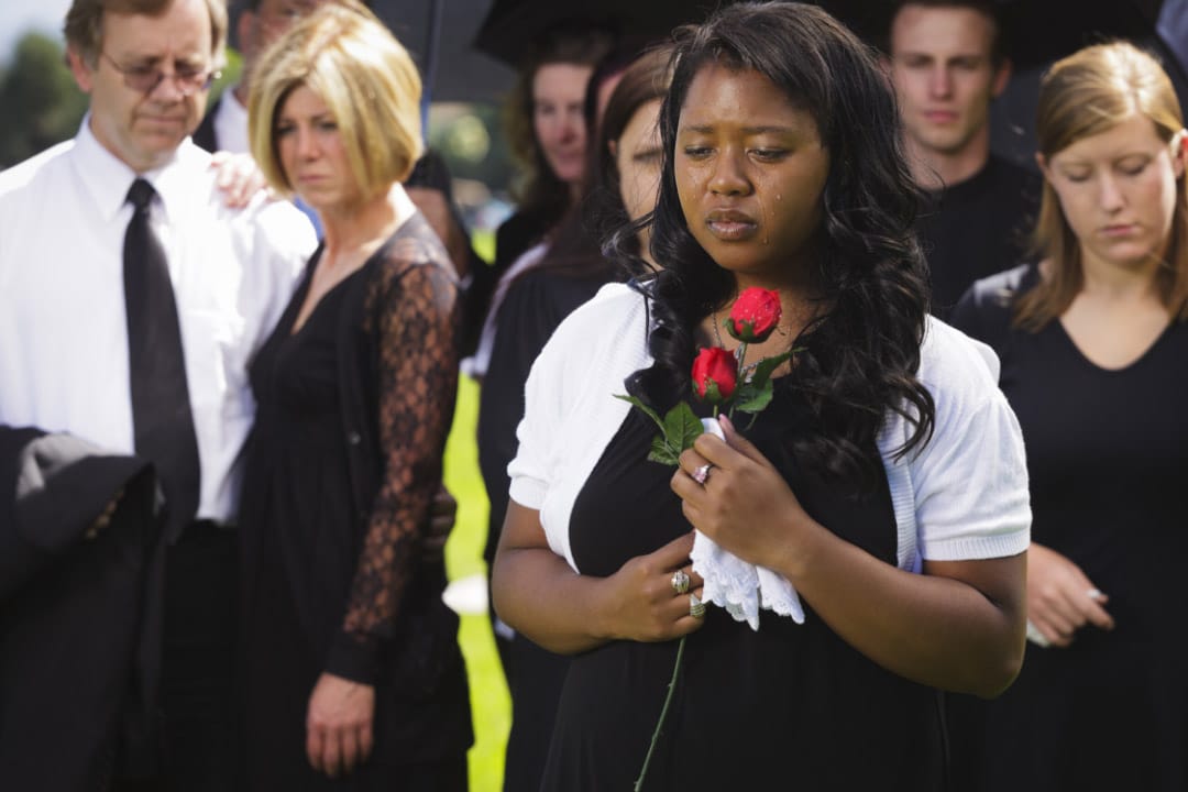 A woman mourning her loss at a funeral