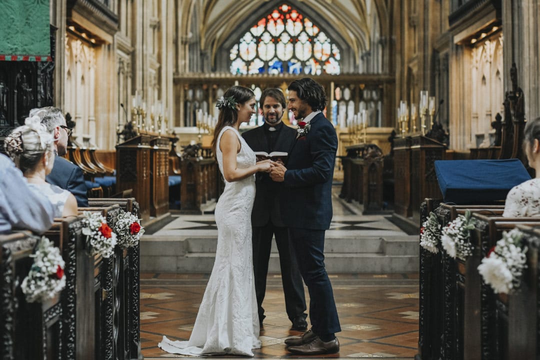 Minister officiating wedding for happy couple in church