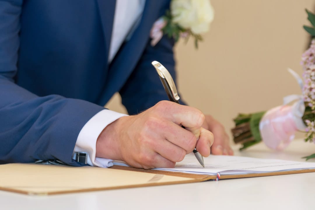 Minister signing the marriage license